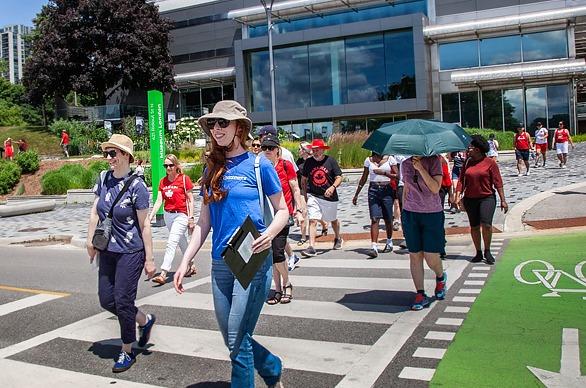 A group of people attending an outdoor walking tour held by Museum London, locate din London, Ontario
