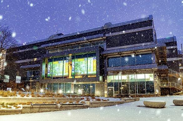 The exterior of the Museum London building at night with snow falling, located in London, Ontario