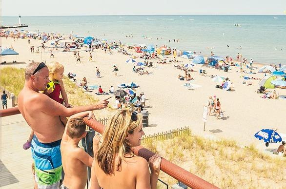 A family enjoying the view overlooking Grand Bend's beachfront on a hot summer day