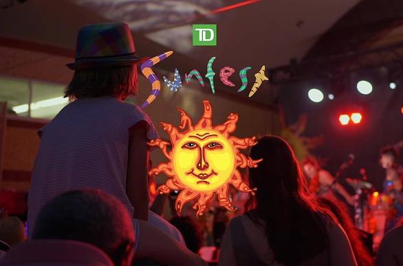 A crowd of people watching a live performance outdoors at the TD Sunfest held in Victoria Park, located in London, Ontario