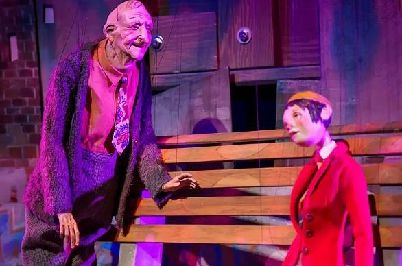 A puppet of a old man and younger woman from the theatre production Wonderful Joe