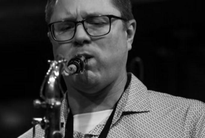 A black and white photo of Barry Usher playing the saxophone.