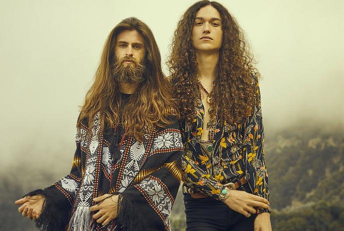 Cody Bowles and Kevin Comeau posing for the camera outside on a foggy mountain.