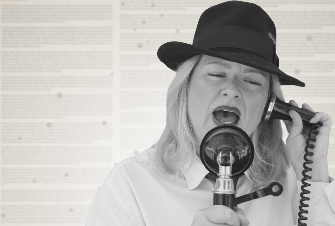 A woman in a hat sings into a vintage microphone with a newspaper background.