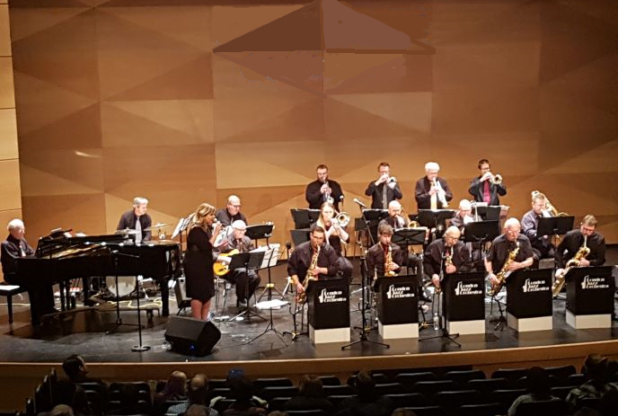 The London Jazz Orchestra onstage with their instruments.