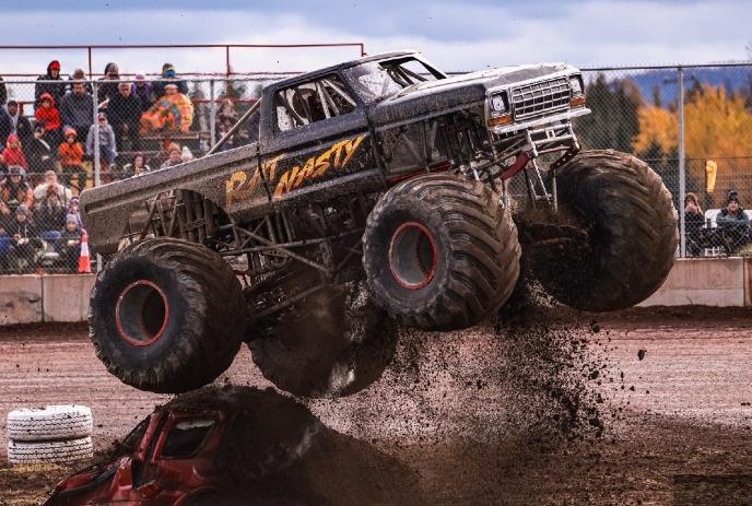 A monster on an outdoor track, truck going off a jump.