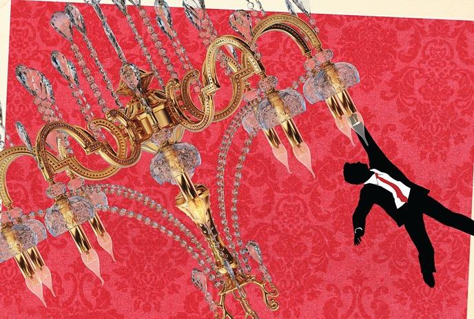 A person in a suit hangs from the bottom of a chandelier.