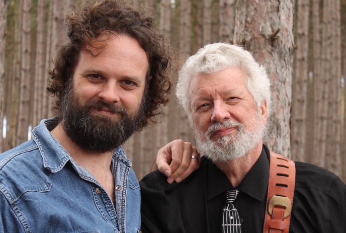 Paul & Trevor Mills posing for a picture under the tree trunks.