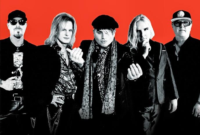 Five artists posing against vivid red backdrop.
