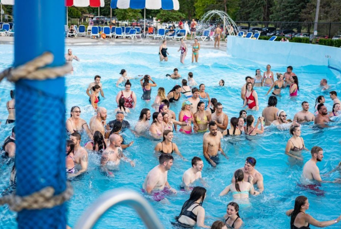 Large group of adults swimming in the wave pool at East Park.
