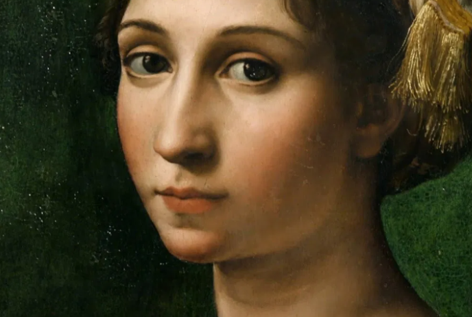 Portrait of a person looking directly into the camera, with a green background behind them.