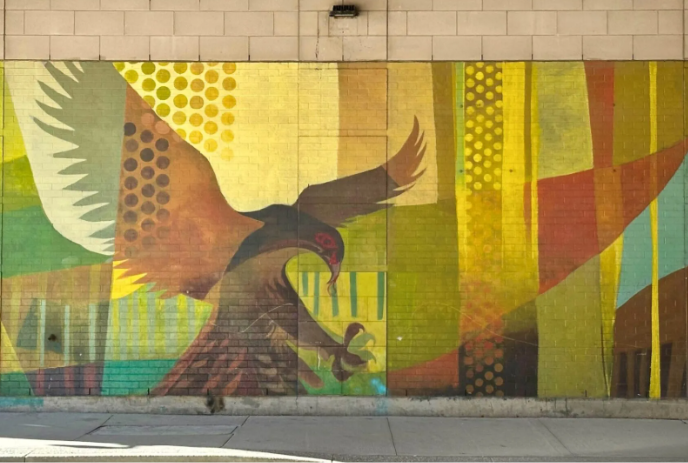 Mural of a bird landing located in an underpass in London.