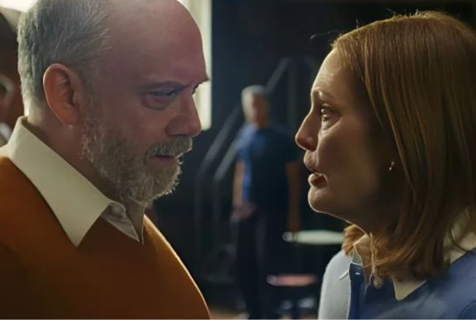 Two people looking intently at one another with a person looking on in the background.
