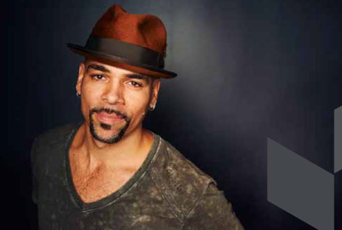 Man wearing a dark gray sweater and a hat