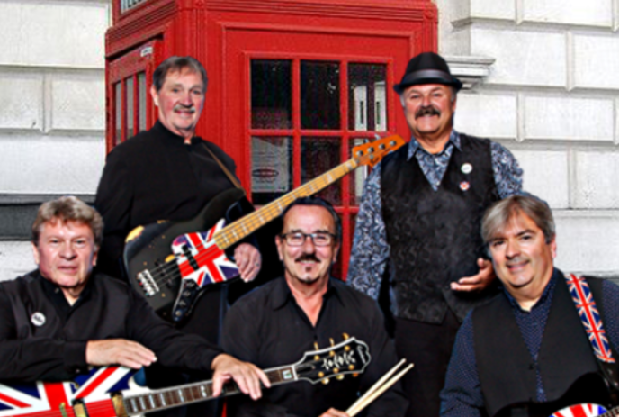 Five band members with their instruments in front of a red phone booth.