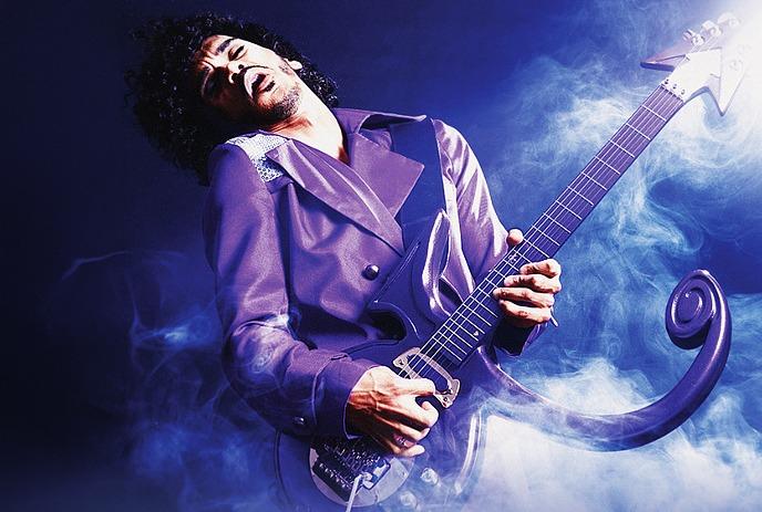 A musician performs under vibrant purple stage lights.