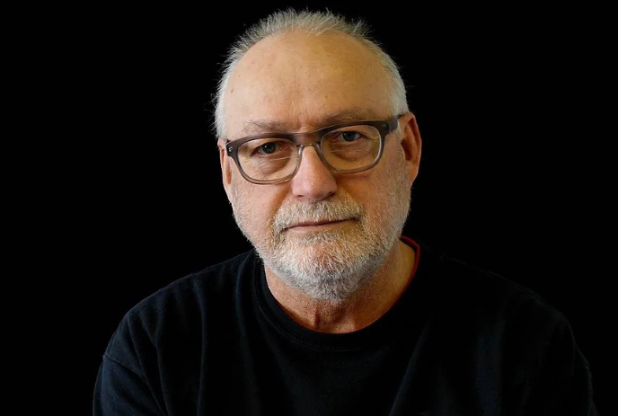 A headshot of Wyn Geleynse against a black background.