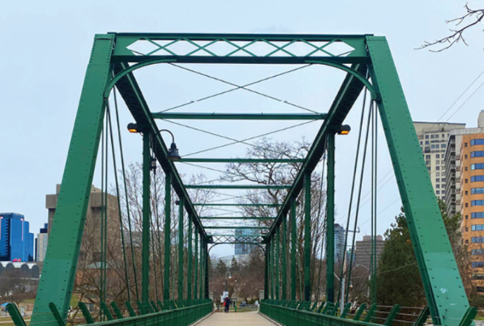 Green pedestrian bridge over the Thames River in downtown London, Ontario.