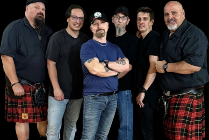 Six members of the group stand together for a photo.