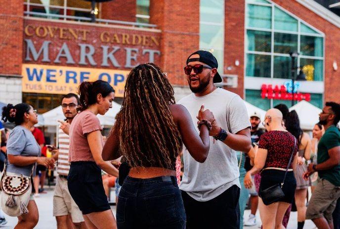People dancing at the Covent Market Rotary Square.