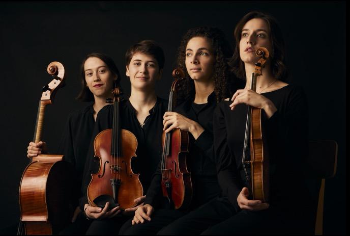 Four women in black attire sit with string instruments against a dark background.