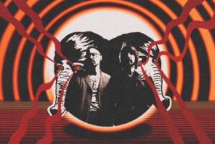 Two figures stand before bold orange rings, framed by black elephants with red branching lines from their eyes.
