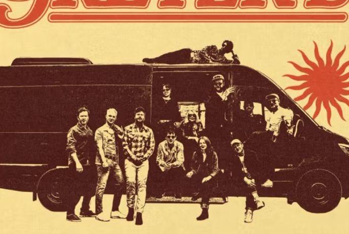 A retro yellow-and-black photo of the band by a van, one person on the roof, with an orange sun in the background.
