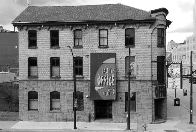 Call the Office Bar & Nightclub sign on a brick wall in black and white, evoking a vintage urban vibe.