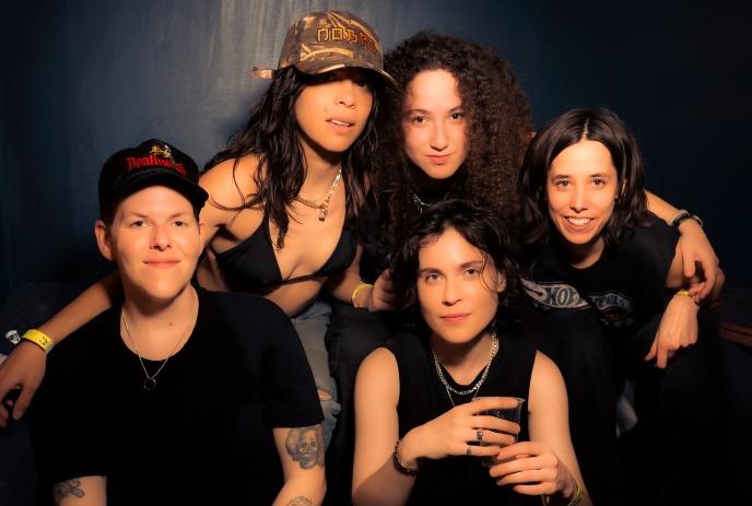 5 band members of the band NOBRO, posing together for the camera in front of a black background.