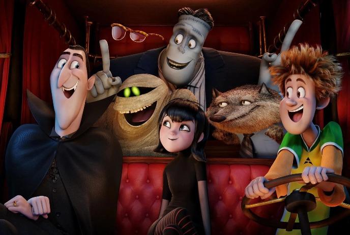 Animated characters from Hotel Transylvania ride together in a red-curtained vehicle, smiling and interacting.