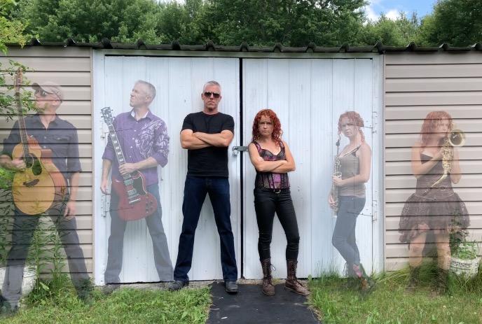 A man and a women posing with their arms crossed against a shed, with faded outlines of them playing instruments beside them.