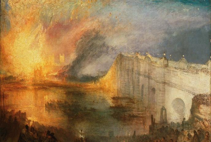 Flames rise over the river as crowds watch from a bridge lit by the burning night sky.
