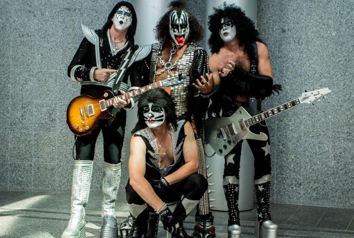 The group members of the band Kiss hamming it up for a photo.