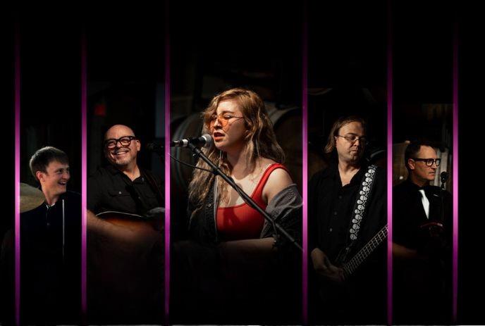 Gravity Junky Band performing live on stage with vocals and instruments.