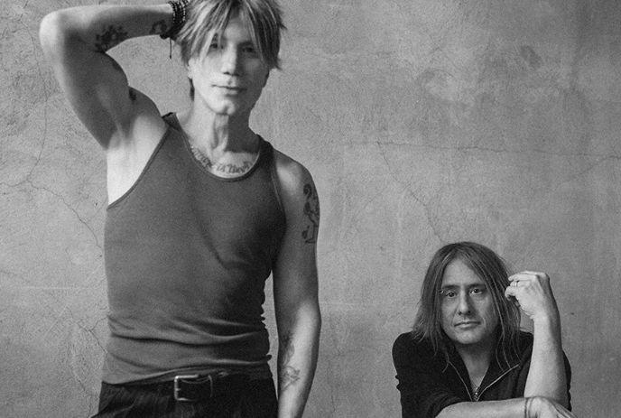 A black and white photo of John Rzeznik and Robby Takac, posing for the camera.