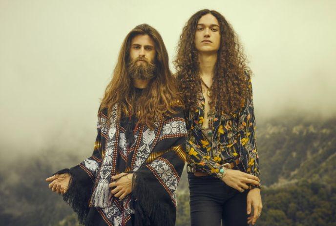 Cody Bowles and Kevin Comeau posing for the camera outside on a foggy mountain.