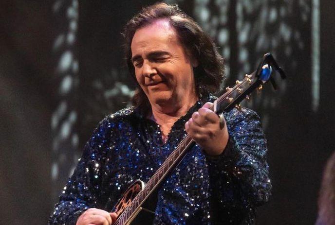 Will Chalmers performing on stage as Neil Diamond, wearing a glittering blue suit.