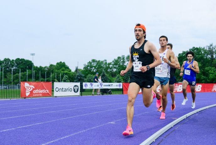 Runners competing in a distance race on the track at the 2024 Bob Vigars Classic
