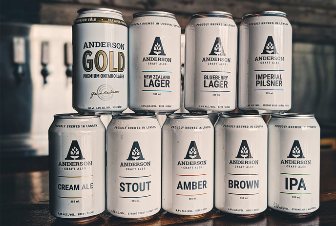 Various cans of beer stacked on each other from Anderson Craft Ales brewery