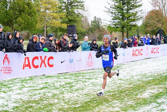 A runner heading for the finish line at the 2024 Canadian Cross Country Championships