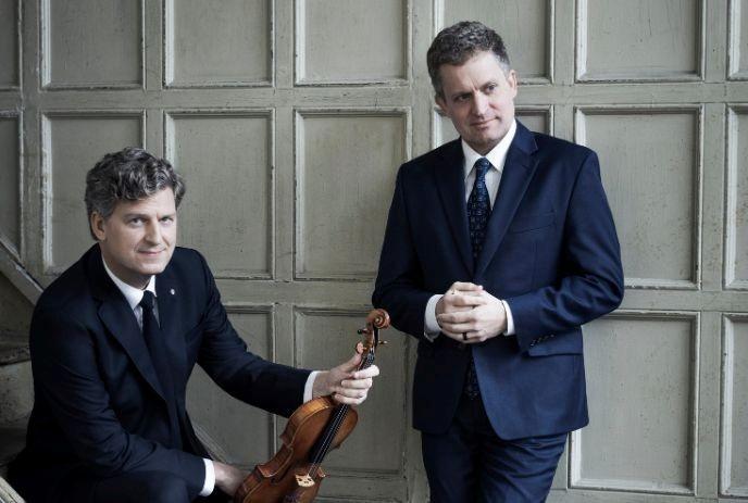 James Ehnes and Andrew Armstrong standing against a grey wall.