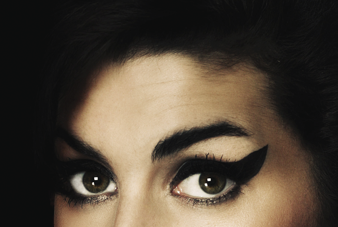 Close-up of Amy Winehouse with her signature black makeup.