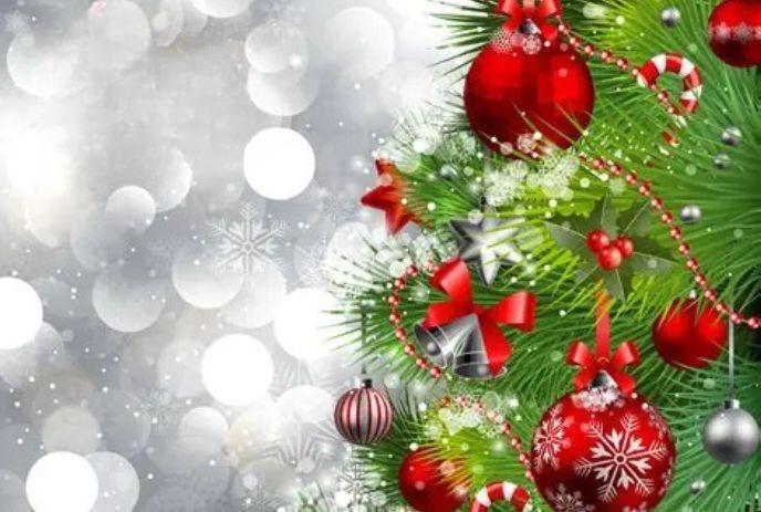 Decorated Christmas tree with red bows, baubles, candy canes, and stars against snowy background.