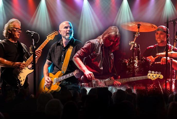 Members of April Wine playing live on stage