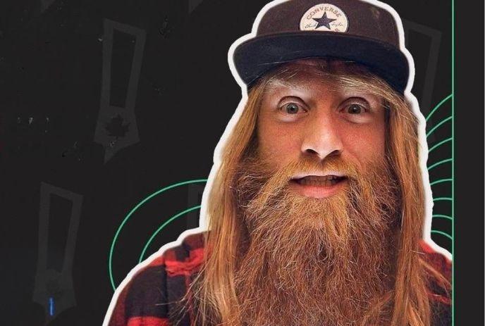 A face portrait of Jason Allen with a flowing beard and cap, staring at the camera, giving a fun, quirky expression.