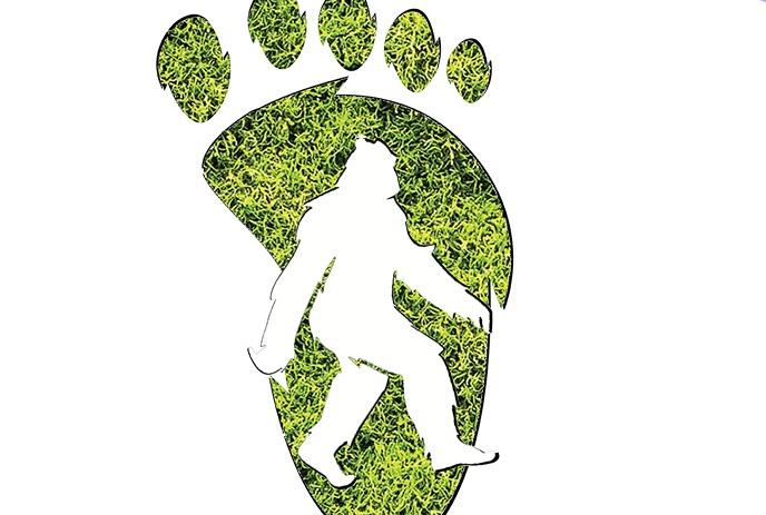 Big green footprint with image of bigfoot walking inside it.