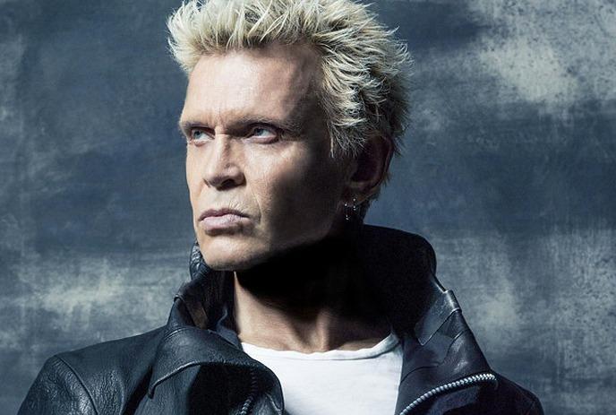 Billy Idol with a blue background behind.