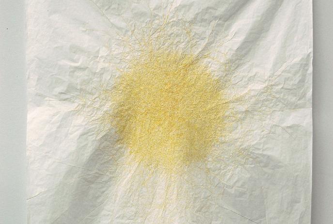 Yellow lines burst outward on crumpled white paper, forming a soft sunlike abstract pattern.