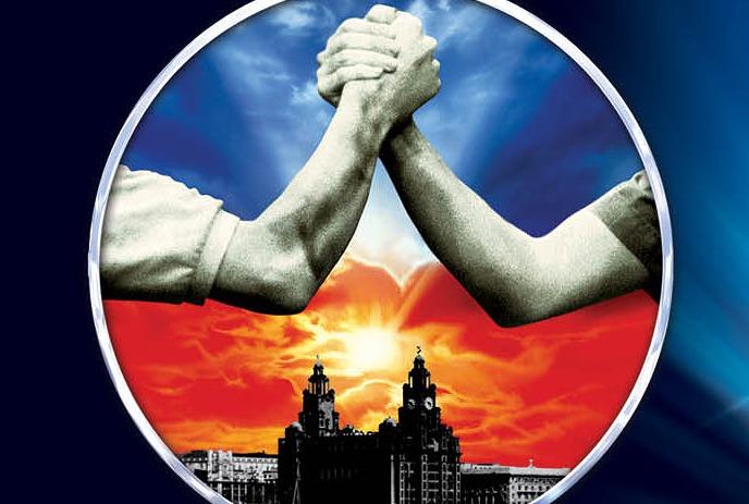 Two arms clasp in unity above a sunset-lit skyline, framed by a circular border.