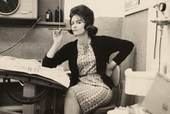 A black and white photo of Bonnie Parkinson. sitting in a chair wearing a dress.